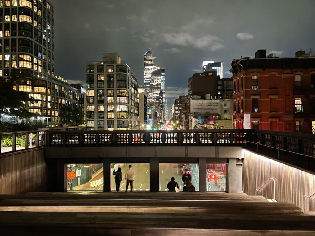 Looking out onto Tenth Avenue from the High Line, at night in New York City.