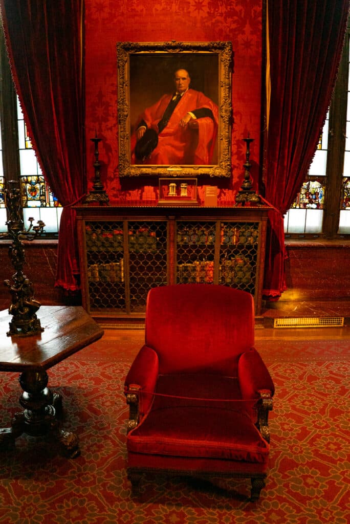 Painting of J.P. Morgan on the wall of a red room inside the Morgan Library & Museum in New York City.