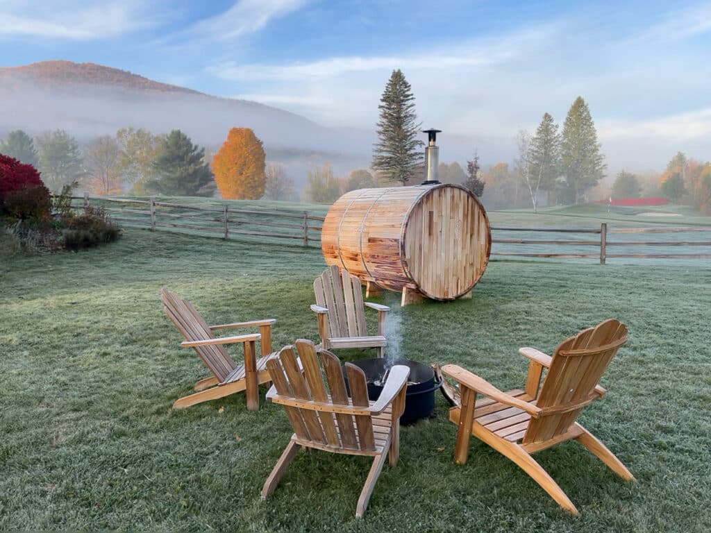 A smoldering fire pit and barrel sauna on the grounds of Wylder Windham Hotel in Windham, NY.