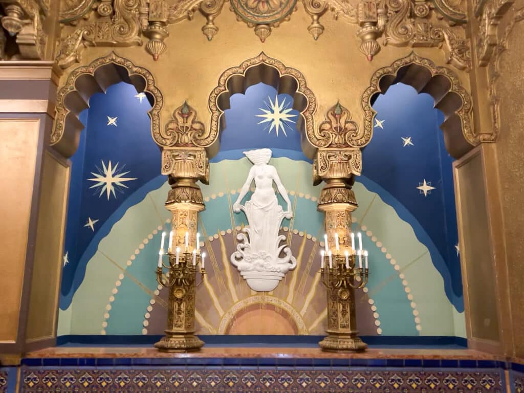A female deity carved into an ornate wall on the mezzanine level at United Palace theater in New York City.