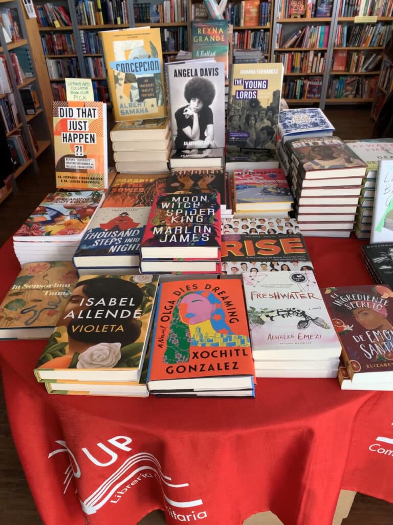 A table of books for sale in a bookstore. 