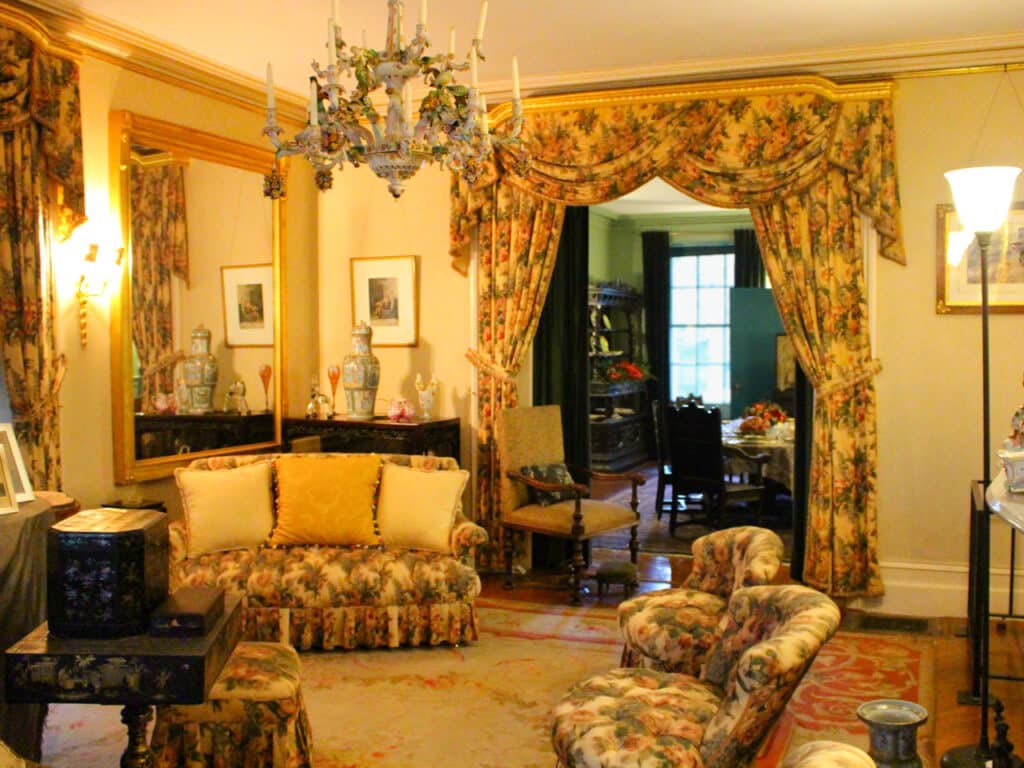 A room with floral furniture and curtains inside the Home of Franklin D. Roosevelt National Historic Site.