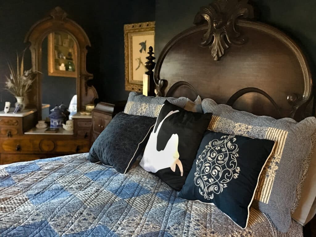 A guest room with antique furnishings at Fainting Goat Island Inn in Nichols, NY.