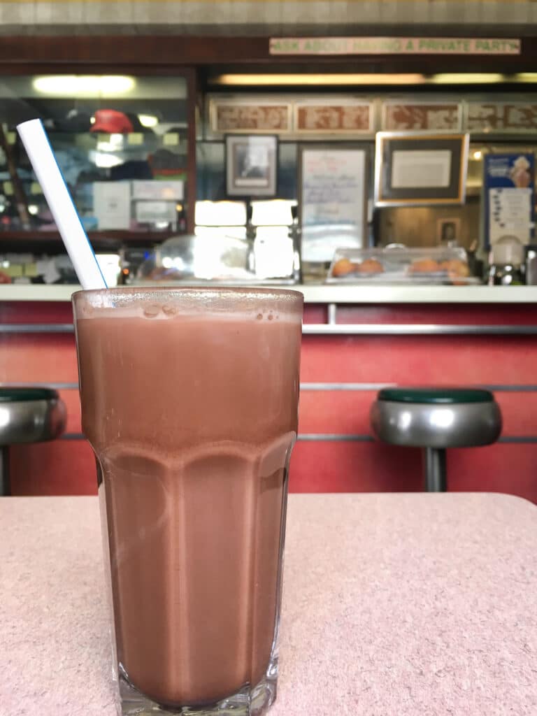 Egg cream on a table in a diner.