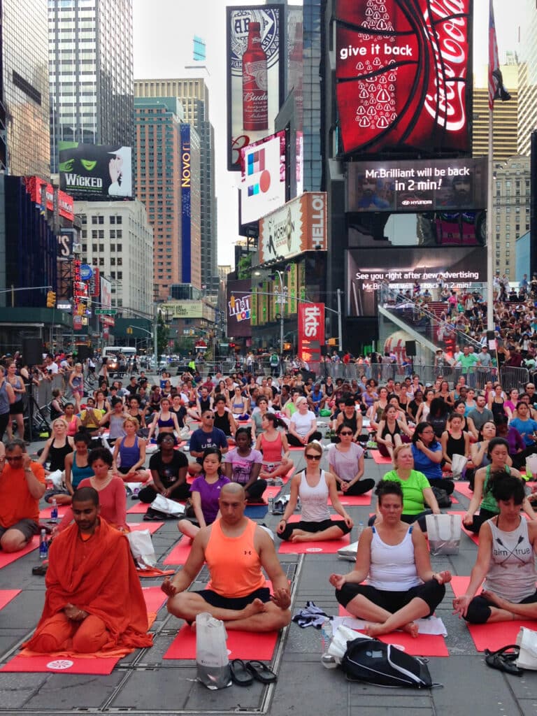 Hundreds of people doing yoga in Times Square in New York City.