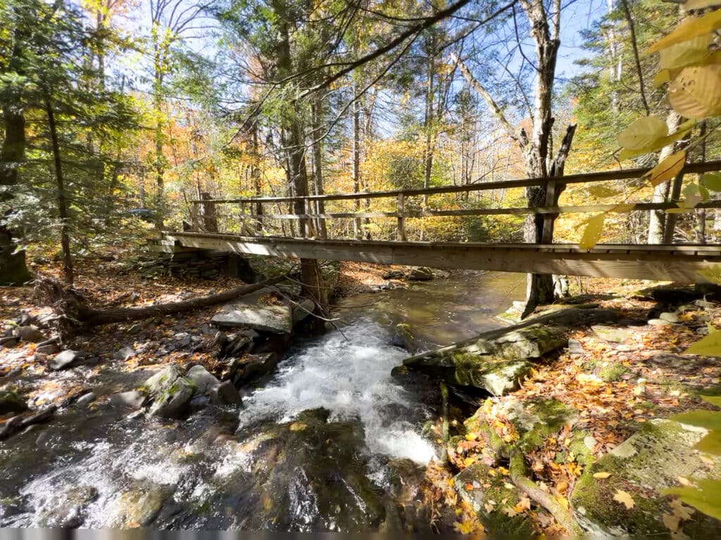 Wooden bridge over a creek on a hiking trail in the Catskills in New York.