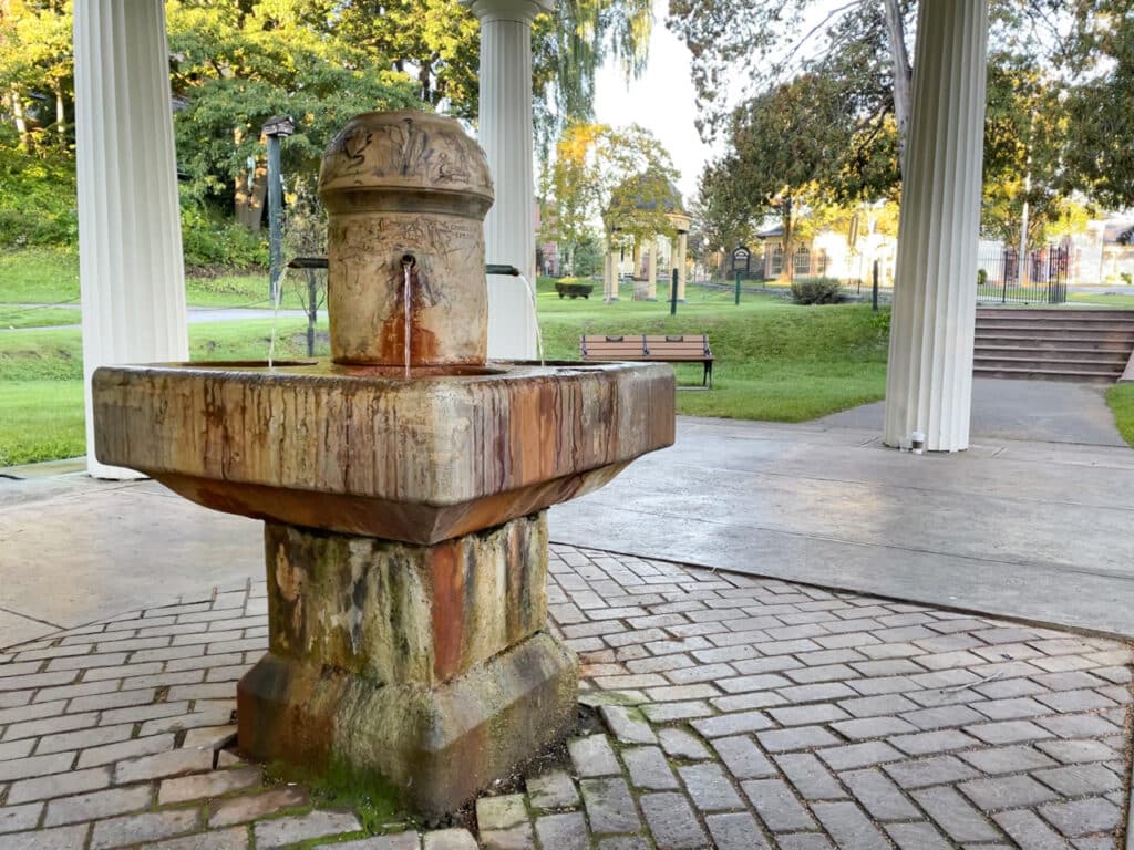 An outdoor fountain with mineral water flowing from three separate spouts. 