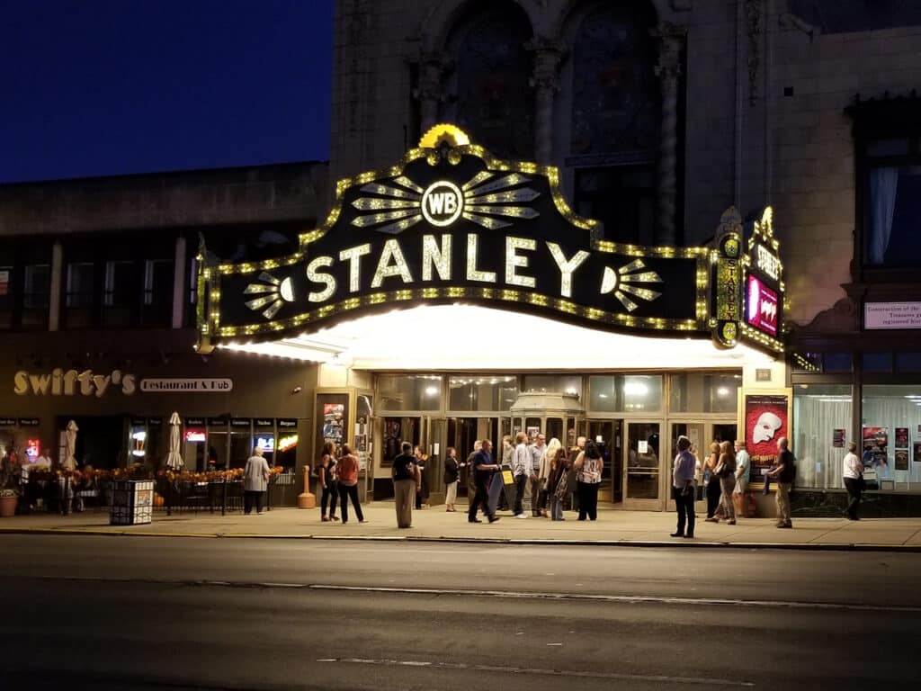 Exterior of the Stanley Theatre in Utica, NY at night.