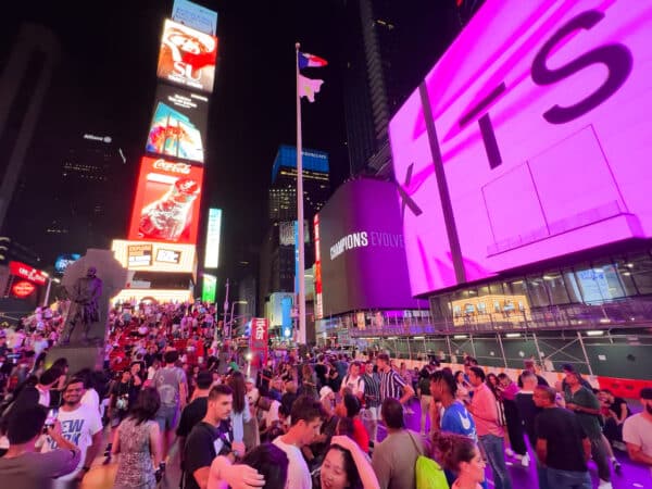 Crowds of people in Times Square, New York City at night.