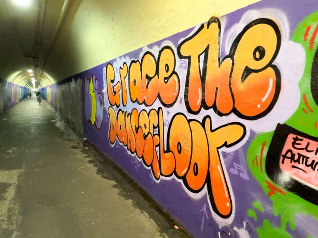 Colorful graffiti art on the walls of a subway tunnel in New York City.